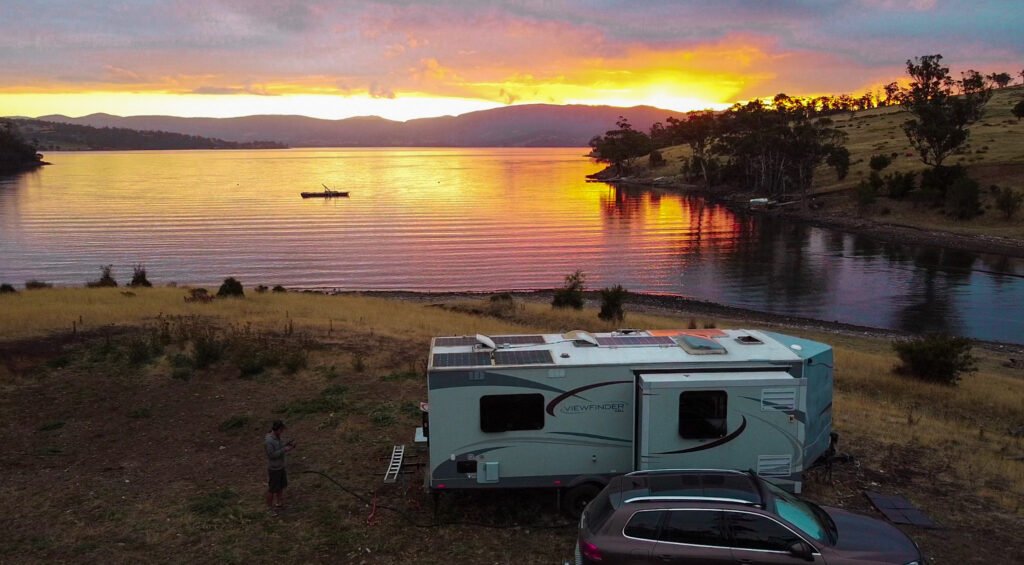 bruny island- The sunsetting over the bay with our caravan