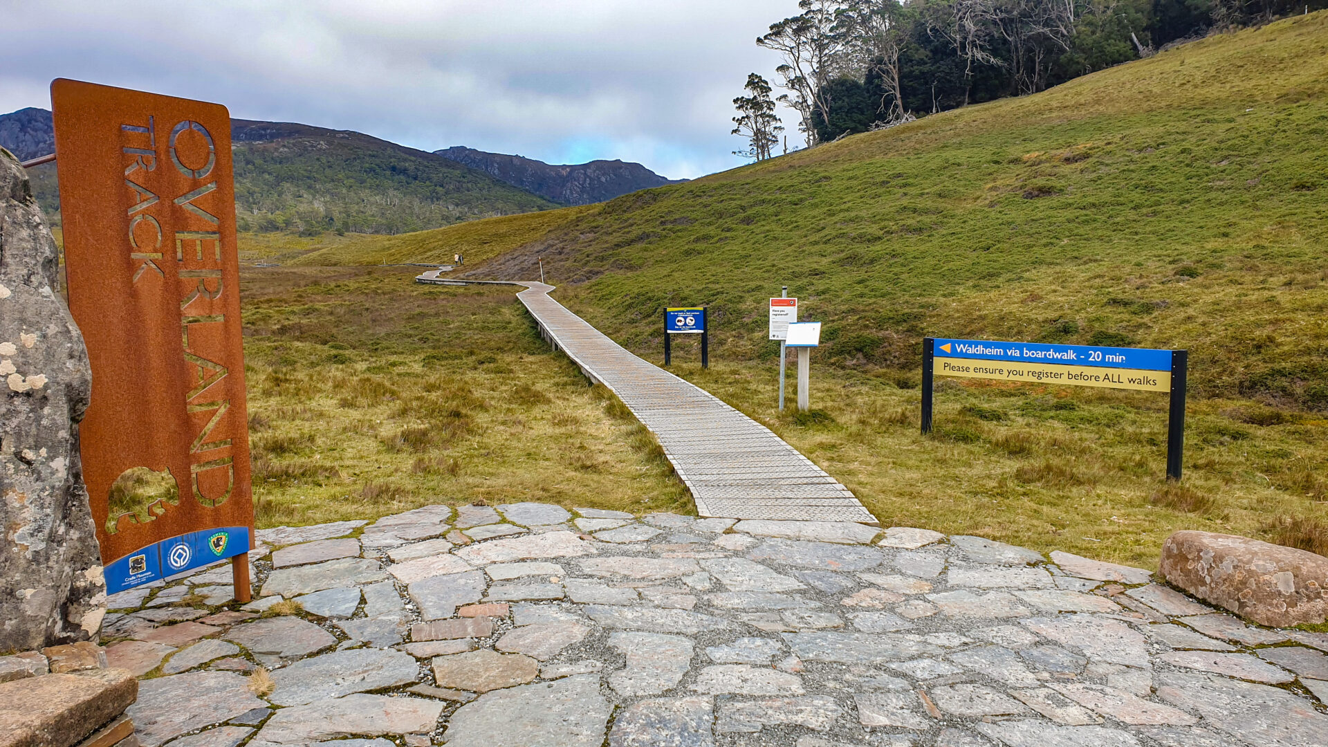 A boardwalk path- with signs letting you no it's the beginning of the overland Track